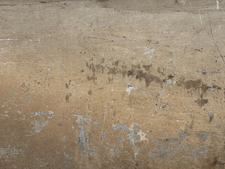 shabby wall of a golden hue, pale yellow rough plaster, texture like painted concrete