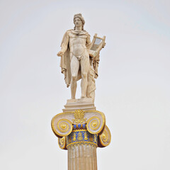 Apollo's marble statue, the ancient Greek god of Arts, on a Corinthian rhythm column capital....
