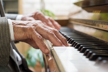 Old person playing the piano. Wrinkled hands. old musician.