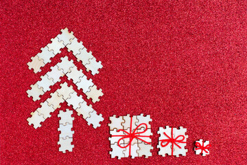 Puzzle Christmas tree and gifts on red background