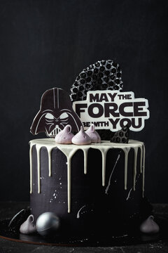 Kyiv, Ukraine - October 11: Star Wars cake with black cream cheese frosting and white chocolate drips decorated with edible  Darth Vader head silhouette and "May the force be with you" text