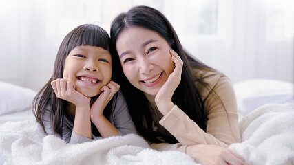 Portrait of asian mother and child daughter playing having fun together. Beautiful face of funny girl mommy. Fun love family day lifestyle, single mom love mother’s day. leisure time holiday concept