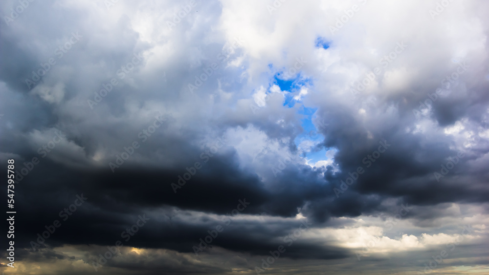 Wall mural the dark sky with heavy clouds converging and a violent storm before the rain.bad or moody weather s