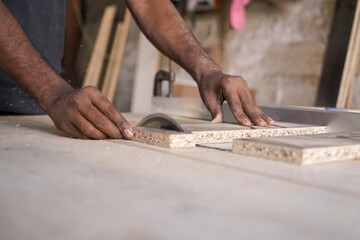 closeup shot of Circular saw in action, a carpenter cutting a plywood. manufacture of wooden furniture. Wooden workshop, making of a furniture, carpentry