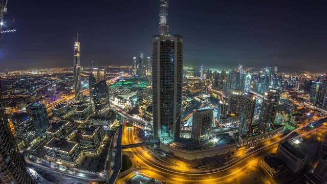 Dubai Downtown day to night transition timelapse modern towers panorama from the top in Dubai, United Arab Emirates. Traffic on the road and music fountain