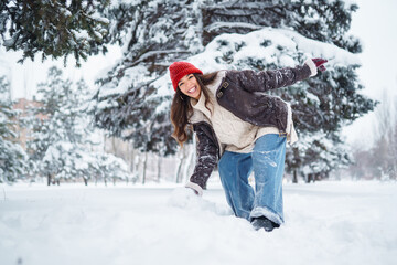 Happy woman  enjoying first snow in the forest. Holidays, rest, travel concept