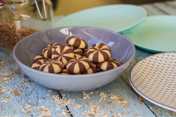 Sweet circle cookies in the bowl on rustic wooden table