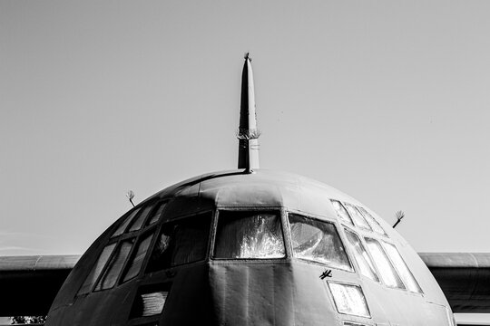 Air force AC-130 Hercules airplane from the front nose with sky in the background, retired military cargo aircraft