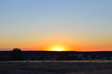 Sunrise with clear blue early morning sky in the village in summer