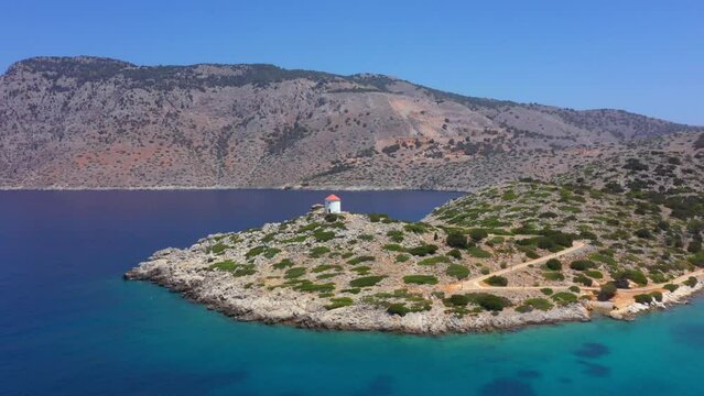 Panormitis bay, iconic windmill with Crystal clear waters of Symi island
