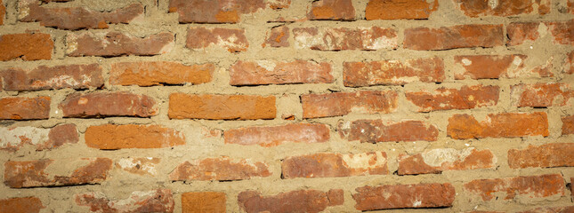 Grunge red brick wall. Brick wall of red color, wide panorama of masonry. Panoramic view