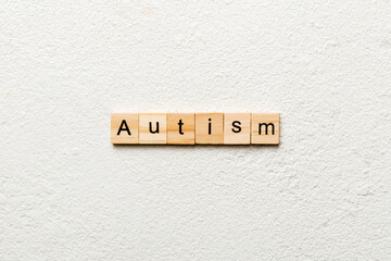 autism word written on wood block. autism text on table, concept