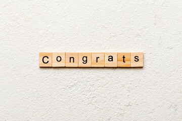 Congrats word written on wood block. Congrats text on cement table for your desing, Top view concept