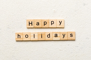 Happy Holidays word written on wood block. Happy Holidays text on cement table for your desing, concept