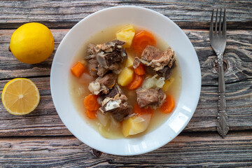 Boiled lamb meat with potatoes, carrots , onions, top view, copy space. Homemade winter comfort food.