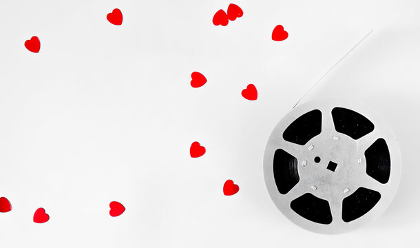 cinema concept layout. film strip and heart confetti isolated on white background. flat lay. top view. copy space