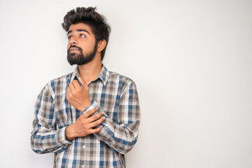 young hispanic bearded man wearing plaid shirt over white background with positive expression, has...