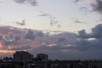 Sunset over the city. View of the city against of  fluffy clouds. Background. Israel.

