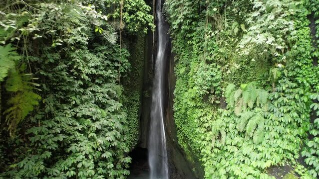 Big strong waterfalls embedded in the beautiful green jungle of Bali filmed by drone