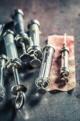 Dirty and old needle and syringes in steel container.