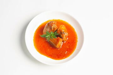 Canned food, sardines in tomato sauce in plate on white background, copy space
