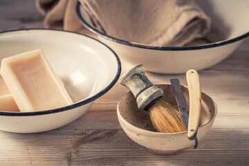 Old and unique barber equipment with grey soap and brush.