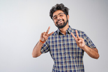 Young Indian businessman against white background