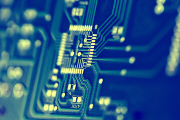 Macro shot of the back side of a circuit board. Close up of the blue circuit board
