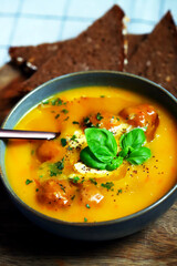 Pumpkin carrot soup with meatballs in a bowl. Autumn menu.