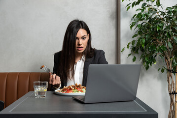 Young frustrated business woman trying to eat her meal on lunch break in cafeteria but she cant...