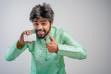 Young indian man wearing traditional and showing card on white background