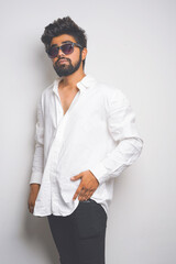 young indian man wearing white shirt and sunglasses. fashion concept. fade effect picture