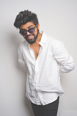 young indian man wearing white shirt and sunglasses. fashion concept. fade effect picture