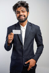 young indian Business man handing a blank business card Isolated on white.