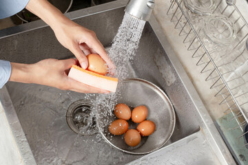 Wash the eggs in the sink to remove any residues and manure before cooking.