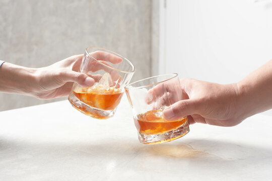 Man And Woman Clinking Whiskey Drinking Alcohol Together At Home, Young People Friendship Concept