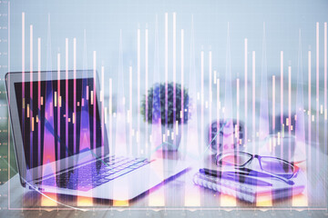 Stock market graph on background with desk and personal computer. Double exposure. Concept of financial analysis.