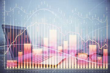 Stock market graph on background with desk and personal computer. Double exposure. Concept of financial analysis.