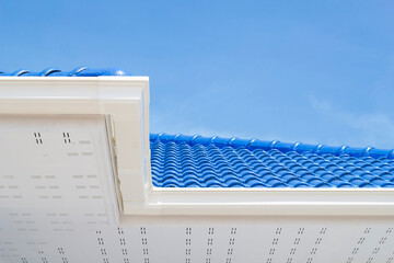 Drainage System rain with white vinyl gutter modern style in new home on blue sky background. © Pannarai