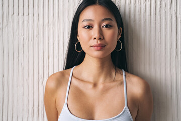 Portrait beautiful korean woman, posing as asian model against textured wall at home