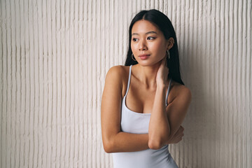 Portrait of shy and beautiful korean woman, posing as asian model, looking away