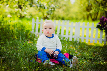 little child playing in the grass