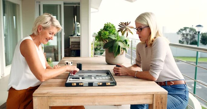 Women play board game on balcony, senior friends at table and enjoy weekend vacation in Australia. Problem solving in senior people on holiday, memory of strategy knowledge and backgammon competition