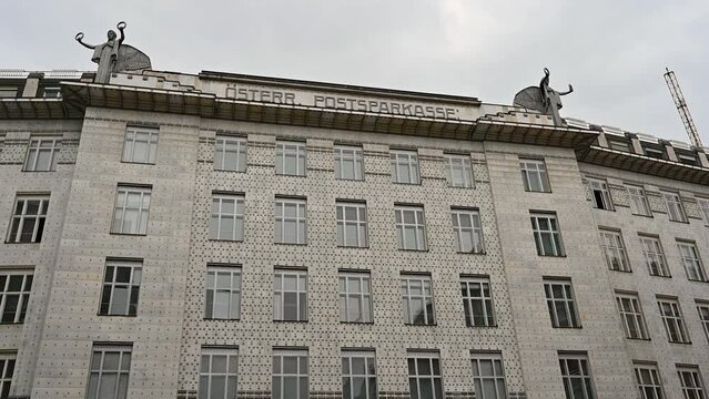 Vienna, Austria, August 2022. Nice slow motion footage with the facade of the &Ouml;sterreichische Postsparkasse, modern post office. On the roof two angels.