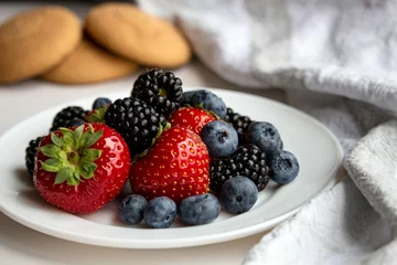 Foto op Plexiglas Closeup of a Composition with berries on a white plate and sweet cookies in the background © Ophelie Sosoyan/Wirestock Creators
