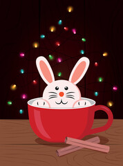 cute rabbit in a red cup on the background of a wooden wall and a New Year's garland