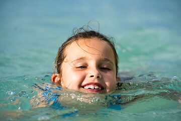 Fototapeta na wymiar Kid Learning Swimming With Swimming Disc Or Ring