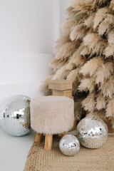 The concept of Christmas decor. A modern eco-friendly Christmas tree decorated with gifts and shiny...