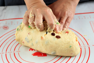 Home Pastry Chef Kneading of the Dough for making Artisan Fruit Bread or Panettone