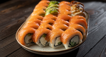 Sushi roll set Philadelphia with salmon, avocado, cream cheese on wooden background. Sushi menu. Japanese food